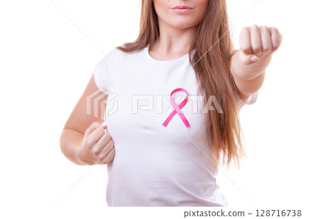 Woman wih pink ribbon on chest punching boxing 128716738