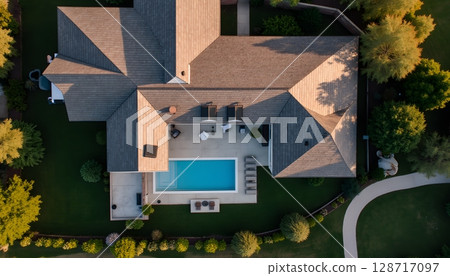 Elegant Aerial View of Modern House with Pool Surrounded by Lush Greenery and Landscape 128717097