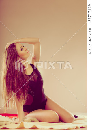 Girl posing on the bed. 128717149