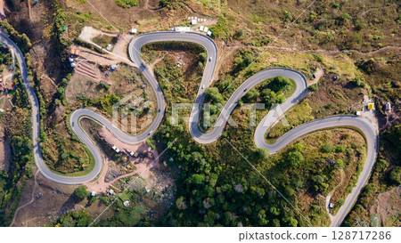 Aerial view of curvy road with hillside resorts up to Phu Tub Berk in Phetchabun, Thailand 128717286