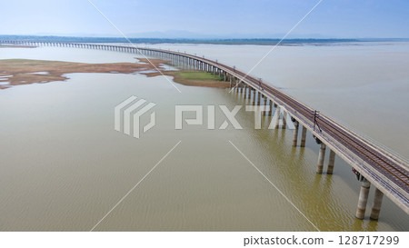 Aerial view of railway track bridge at Pasak Chonlasit Dam in Lopburi, Thailand Aerial view of railway track bridge at Pasak Chonlasit Dam in Lopburi, Thailand 128717299