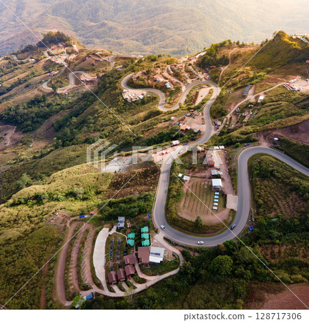 Aerial view of curvy road with hillside resorts up to Phu Tub Berk in Phetchabun, Thailand 128717306