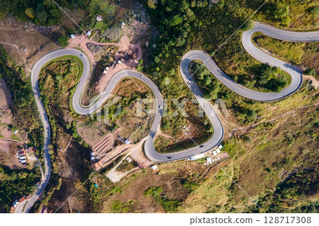 Aerial view of curvy road with hillside resorts up to Phu Tub Berk in Phetchabun, Thailand Aerial view of curvy road with hillside resorts up to Phu Tub Berk in Phetchabun, Thailand 128717308