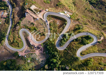 Aerial view of curvy road with hillside resorts up to Phu Tub Berk in Phetchabun, Thailand Aerial view of curvy road with hillside resorts up to Phu Tub Berk in Phetchabun, Thailand 128717309
