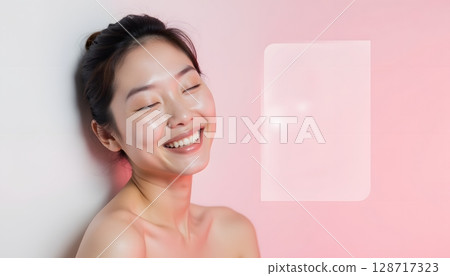 Joyful woman with glowing skin and neutral background, exuding beauty and confidence 128717323