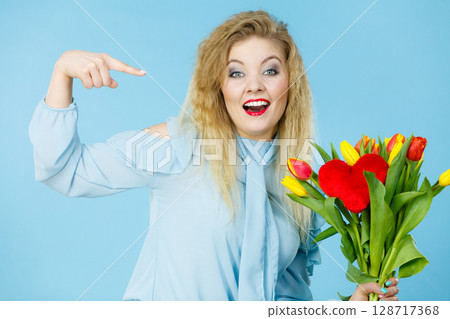 Pretty woman with red yellow tulips bunch Pretty woman with red yellow tulips bunch 128717368