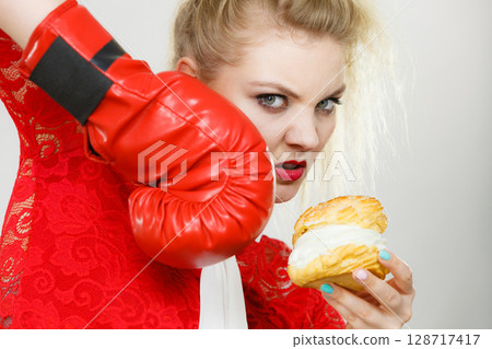 Woman boxing cream cupcake 128717417