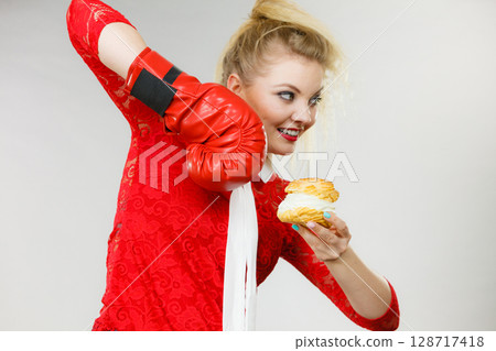 Woman boxing cream cupcake 128717418