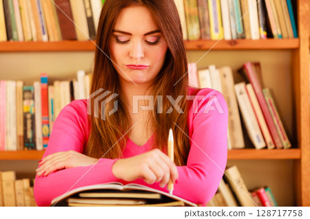 Girl student in college library Girl student in college library 128717758