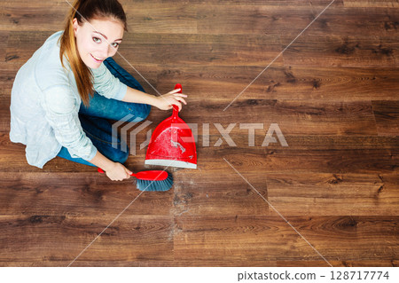 Cleaning woman sweeping wooden floor Cleaning woman sweeping wooden floor 128717774