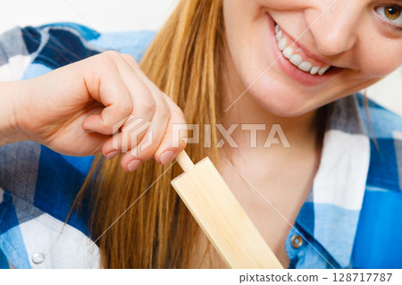 Woman assembling wooden furniture. DIY. Woman assembling wooden furniture. DIY. 128717787