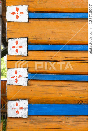 Colorful wooden wall with traditional folk ornaments in Osturna, Slovakia 128718007