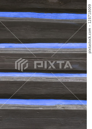 Traditional wooden wall with blue stripes in Osturna, Slovakia 128718009