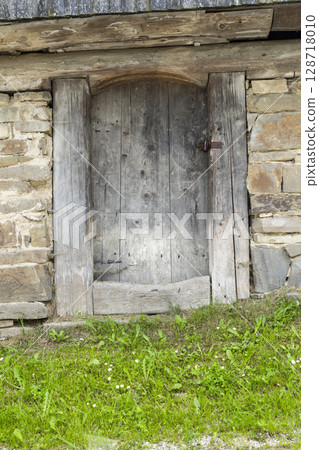 Old wooden door of traditional house in Osturna, Slovakia 128718010