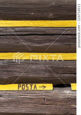 Yellow stripes indicating the direction of the post office in Osturna, Slovakia Yellow stripes indicating the direction of the post office in Osturna, Slovakia 128718011