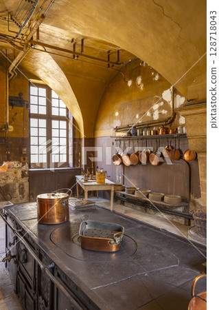 Ancient kitchen showcasing copper pots and pans in Commarin Castle, France Ancient kitchen showcasing copper pots and pans in Commarin Castle, France 128718043