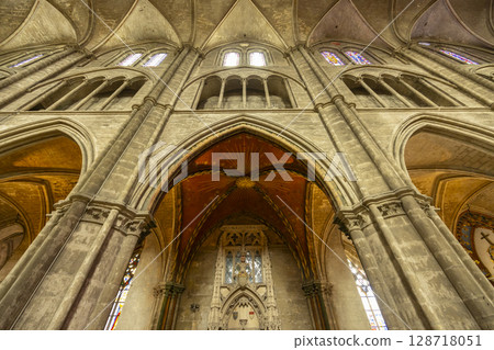 Impressive gothic architecture of Bourges Cathedral showing arches, pillars and stained glass windows 128718051