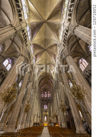 Bourges Cathedral nave showing gothic architecture, stained glass windows and chandeliers in France Bourges Cathedral nave showing gothic architecture, stained glass windows and chandeliers in France 128718052