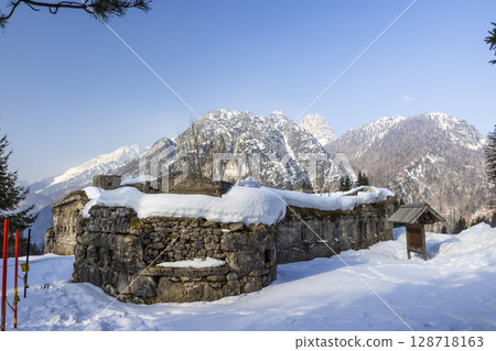 Ruins of Fort Hensel in Tarvisio covered by snow during winter with Julian Alps in background Ruins of Fort Hensel in Tarvisio covered by snow during winter with Julian Alps in background 128718163