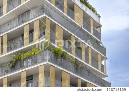 Modern apartment building with balconies and plants growing in Montpellier, France 128718169