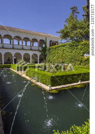 Fountains splashing in the gardens of Generalife Palace in Granada, Andalusia, Spain 128718177