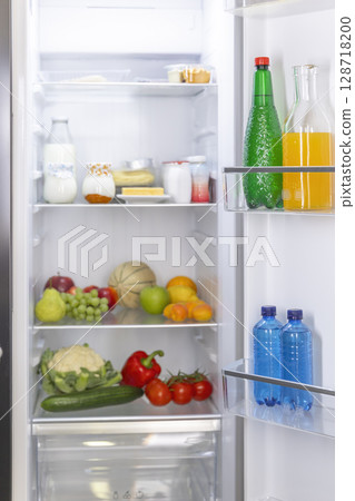 Well Stocked Refrigerator with Fresh Produce and Drinks 128718200