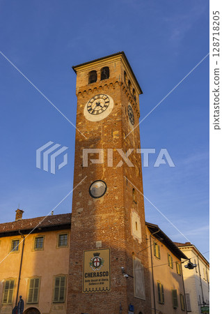 Clock tower standing tall in Cherasco, Piedmont, Italy Clock tower standing tall in Cherasco, Piedmont, Italy 128718205