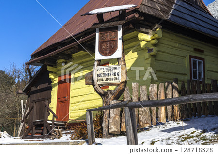 Traditional wooden house in Vlkolinec village in winter with snow and blue sky, Ruzomberok, Slovakia Traditional wooden house in Vlkolinec village in winter with snow and blue sky, Ruzomberok, Slovakia 128718328