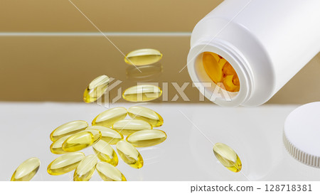 Natural pills, vitamins or supplements on glass shelf on beige background. White bottle with healthy supplements in gel capsules. Omega 3, fish oil or vitamin D3. Organic vitamins, nutrients. Closeup Natural pills, vitamins or supplements on glass shelf on beige background. White bottle with healthy supplements in gel capsules. Omega 3, fish oil or vitamin D3. Organic vitamins, nutrients. Closeup 128718381