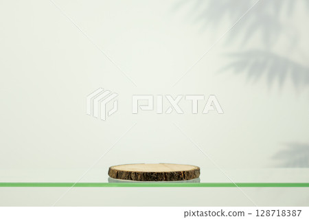 Wooden empty podium on glass shelf on beauty gradient background with palm shadows. Round show case for natural cosmetic products. Concept scene stage for new product, promotion sale and presentation 128718387
