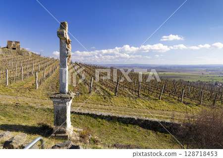 Stone cross overlooking Somlo vineyard in Hungary during sunny day Stone cross overlooking Somlo vineyard in Hungary during sunny day 128718453