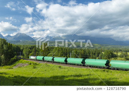 Freight train passing through Strba, Slovakia, near the High Tatras mountains Freight train passing through Strba, Slovakia, near the High Tatras mountains 128718790