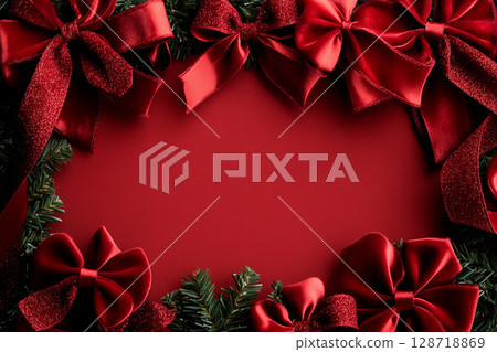 Festive arrangement with glittering red bows and velvet ribbons perfect for holiday greetings or celebration decorations 128718869