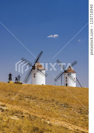 Traditional windmills standing on a hill in Mota del Cuervo, Spain 128718940