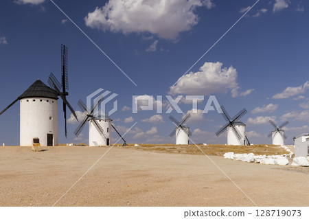 Traditional windmills standing on a hill in Campo de Criptana, Spain Traditional windmills standing on a hill in Campo de Criptana, Spain 128719073