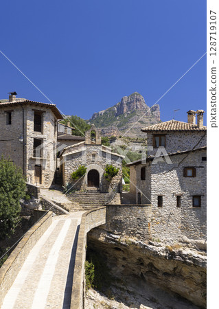 Picturesque village of Roda de Isabena, Huesca, Spain, showing bridge, houses, church and Pena Montanesa mountain 128719107