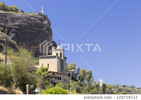 Basilica de la Pena overlooking Graus in Huesca, Spain, featuring cliffside statue 128719112