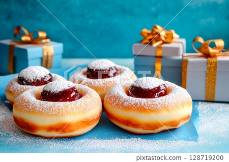 Delicious Hanukkah sufganiyot with powdered sugar and festive gifts arranged for celebration 128719200
