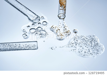 Three test tubes with spilled serums. Demonstration of textures. 128719495
