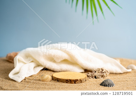 Tropical beach scene with white towel, wooden podium Tropical beach scene with white towel, wooden podium 128719501