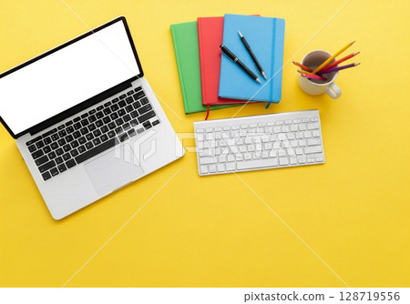 office desk table with laptop, supplies, yellow 128719556