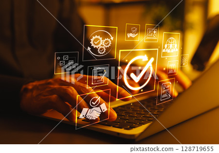 Business Quality Assurance and Compliance Concept. Person using laptop with icons represent quality assurance, compliance, process improvement, certification, success, effective operational standards, 128719655