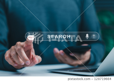AI chatbot search engine technology concept. Person using search bar with AI chatbot icon, intelligent search engines, digital assistants, and modern online queries for fast information retrieval. AI chatbot search engine technology concept. Person using search bar with AI chatbot icon, intelligent search engines, digital assistants, and modern online queries for fast information retrieval. 128719664