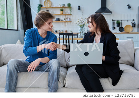 Female social worker working at home with teenage guy 128719785