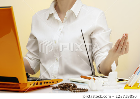 Office meditation for reducing work stress relief concept. Business woman practicing yoga at workplace for relaxing, Self care and mindfulness development. Mental health, healing and balance 128719856