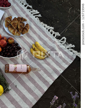 Outdoor Picnic with Fruits, Croissants, and Wine Outdoor Picnic with Fruits, Croissants, and Wine 128719946