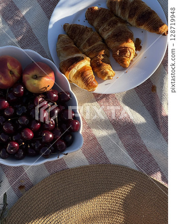 Outdoor Picnic with Croissants, Cherries, and Peaches Outdoor Picnic with Croissants, Cherries, and Peaches 128719948