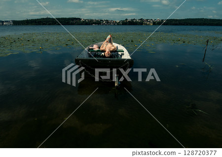 The girl gently holds her dress 128720377