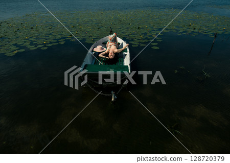 The girl gently holds her dress 128720379