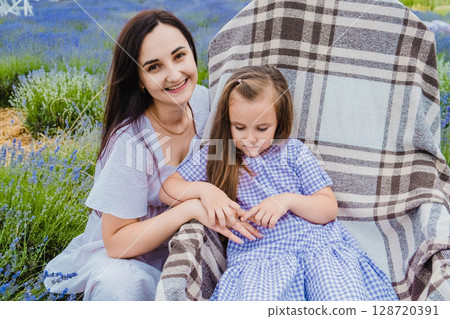 The delicate purple shade of the girl's dress echoes the color of lavender The delicate purple shade of the girl's dress echoes the color of lavender 128720391